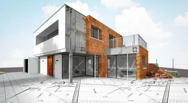 Nowoczesny dom w budowie, z ceglanymi ścianami i betonowymi elementami, leży na planach architektonicznych. To idealny obrazek, by zacząć budowę domu od czego zacząć.