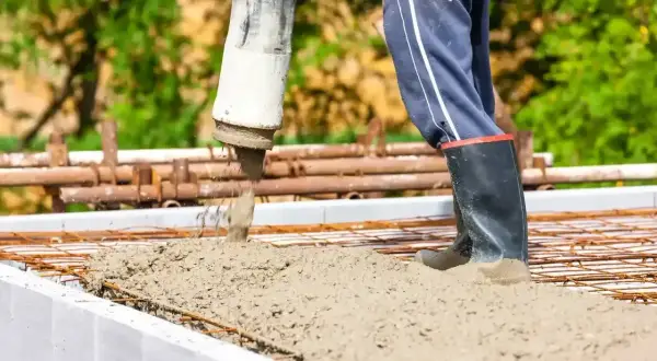 Robot wylewa beton na zbrojenie płyty fundamentowej. Odpowiedni beton na płytę fundamentową to klucz do trwałej budowy.