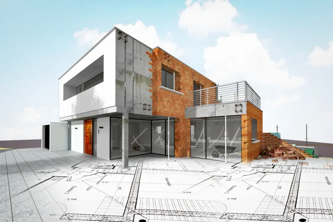 Nowoczesny dom w budowie, z ceglanymi ścianami i betonowymi elementami, leży na planach architektonicznych. To idealny obrazek, by zacząć budowę domu od czego zacząć.